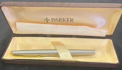 a pen in a box that is open on a table