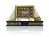 a clock that is sitting on top of a marble stand