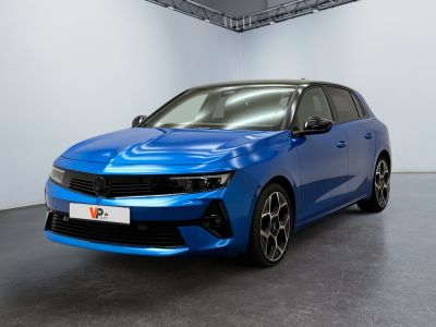 a blue car is parked in a white room with a black floor