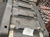 a metal crate with a tag on it sitting on the ground