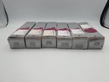 four boxes of lipstick sitting on top of a white table