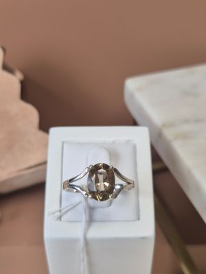 a white box with a silver ring on top of it