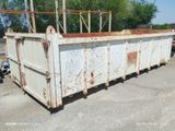 a rusted dumpster sitting in the middle of a parking lot
