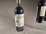 two bottles of wine that are on display in a glass case