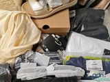 a suitcase full of clothes and shoes on the floor