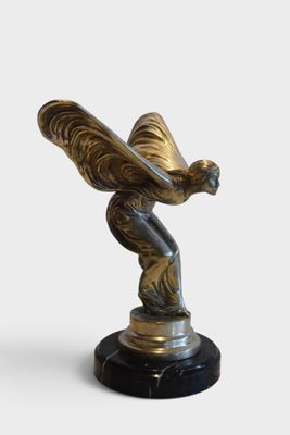 statue of a woman holding a butterfly on a black marble base