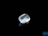 a close up of a white stone on a black surface