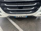 a close up of the front of a truck in a parking lot