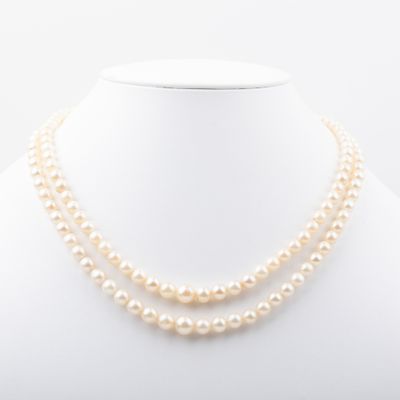 a double strand pearl necklace on a mannequin neck