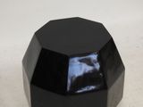 an image of a black hexagonal object on a white surface