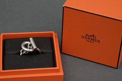 an orange box with a silver ring inside of it on a table