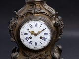 a clock that is sitting on a black table
