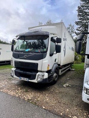 two trucks parked next to each other on the side of the road