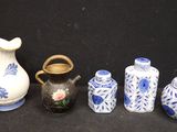 five vases and a vase on a black background