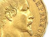 a close up of a gold coin with a man ' s face on it