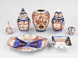 many pieces of pottery that are sitting on a table