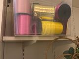 a shelf with a lot of thread and spools on it