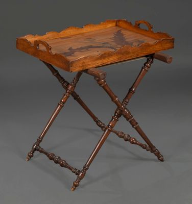 an antique wooden tray with a carved design on it