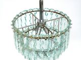 an image of a glass chandelier hanging from a ceiling