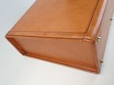 an image of a brown briefcase sitting on top of a white table