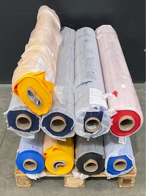 many rolls of different colors of plastic on a pallet