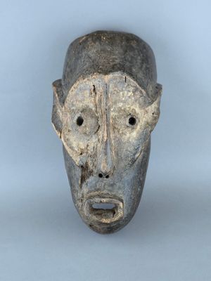 gros plan d'un masque en bois sur fond blanc