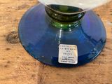 a glass vase with a label on it sitting on a table