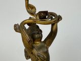 a statue of a woman holding a bird on her shoulder