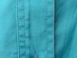 a close up of a button on a blue shirt