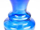 a blue glass vase with a black rim on a white background