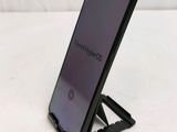 the back of a black phone with a stand on top of it