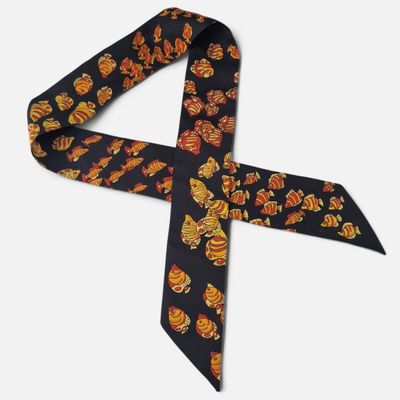 a close up of a black tie with orange and yellow flowers on it