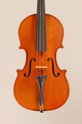 an old violin sitting on top of a white surface