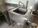 a stainless steel sink in the middle of a kitchen