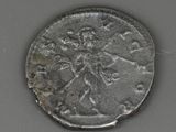 an old silver coin with a bird on it on a table