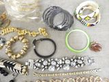 many different bracelets and bracelets laid out on a table