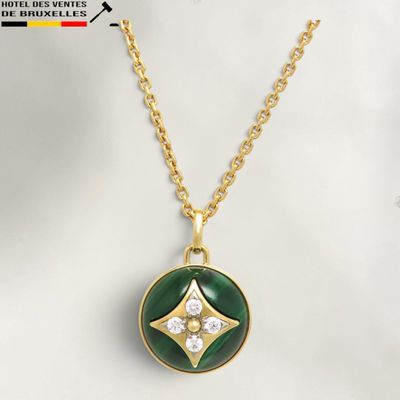 a gold necklace with a green and white pendant on a gold chain