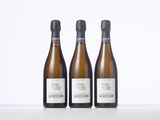 three bottles of wine sitting on top of a white table