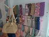 a picture of a room with a lot of clothes hanging on the wall