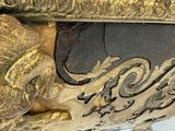 a gold and black vase with a lion on it