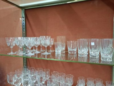many glasses on a glass shelf in a room