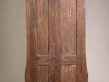 an old wooden cabinet with two doors and a drawer underneath it