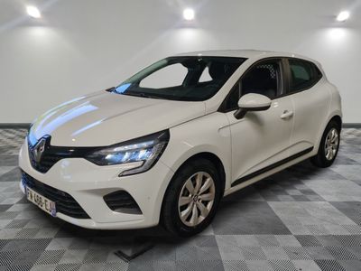 a white car parked in a garage with a checkered floor