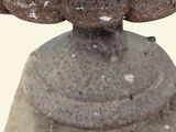 a stone pedestal with a bowl on it
