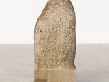 an image of a stone sculpture on a cement surface