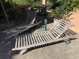 two chaise loungers on the patio with a bottle of water