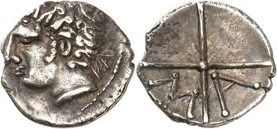 a close up of a silver coin with a face on it