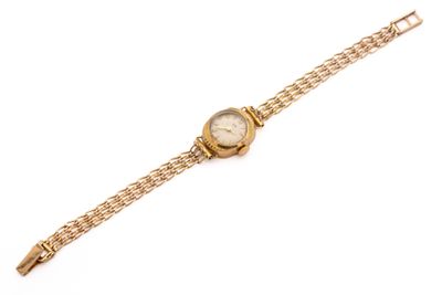 an image of a gold wrist watch with a chain around it