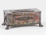 a small metal box with a decorative design on it