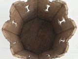 a wooden bowl with holes in it on a table